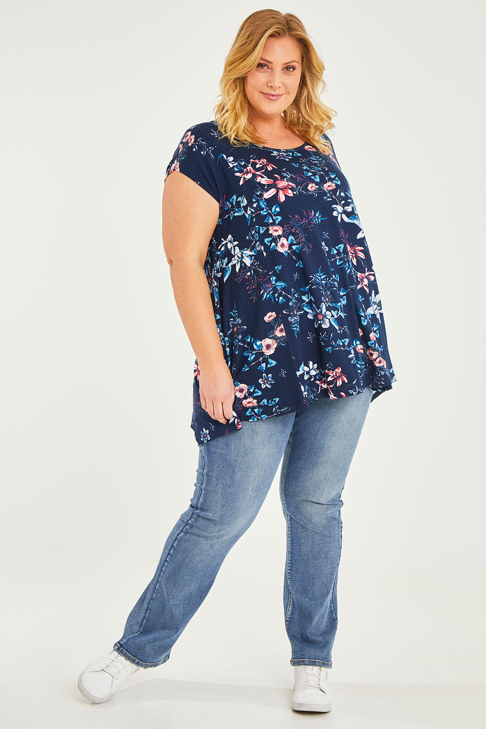 Model Caitlin wearing size 20 of the Belle Printed Drape Tee in colour Floral (Blue), from the front, showing the whole outfit