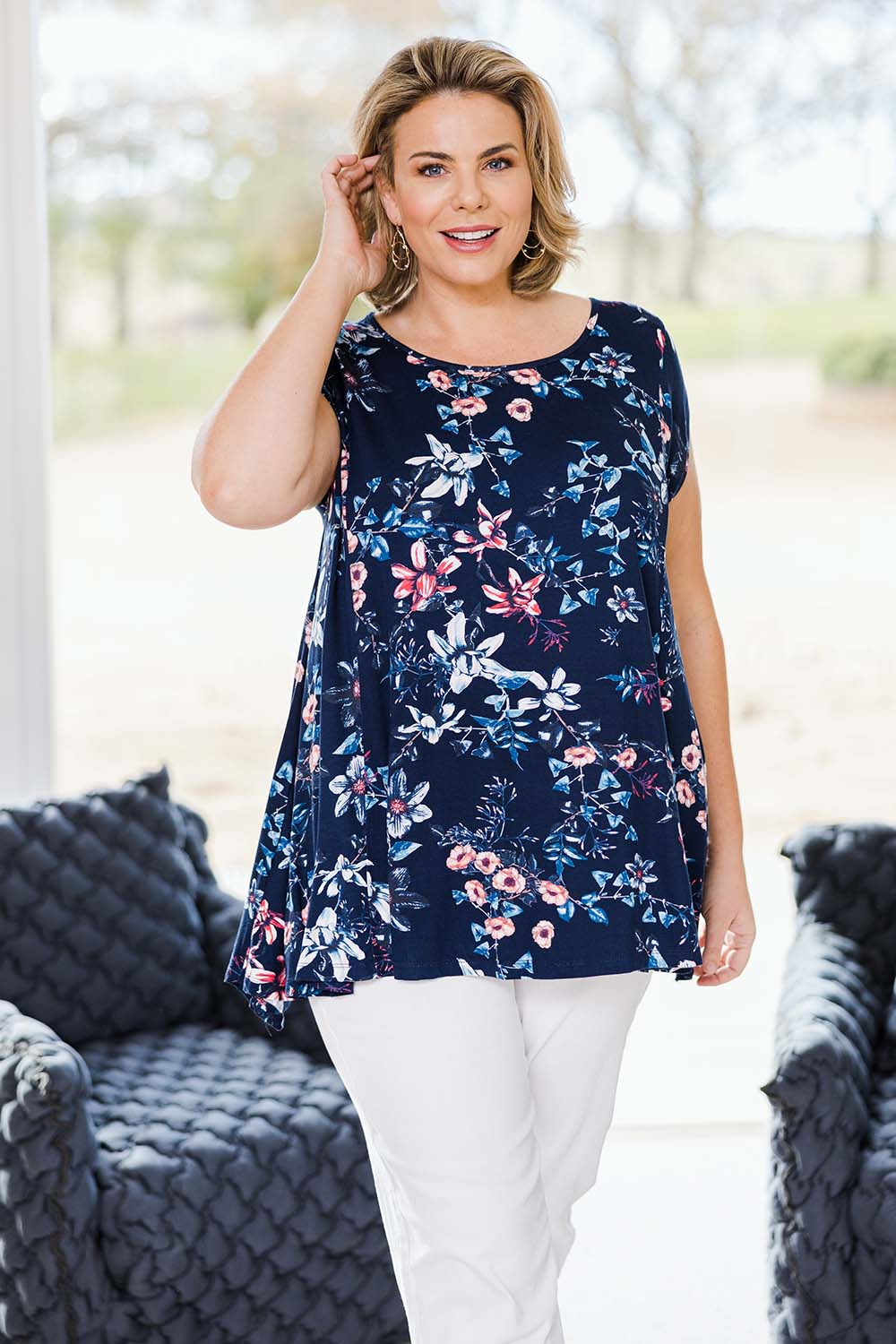 Model Fiona wearing size 16 of the Belle Printed Drape Tee in colour Floral (Blue), from the front, showing the whole outfit