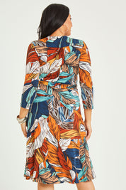 Model Terri-Leigh wearing size 14 of the Belle Faux Long Sleeve Wrap Dress in colour Leafprint (White), from the back