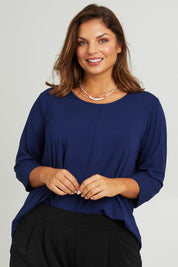 Model Monique wearing size 14 of the Belle Luxe Bamboo Spliced Tee in colour Navy (Blue), from the front, cropped image