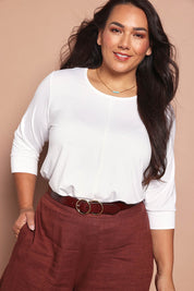 Model Ashleigh wearing size 16 of the Belle Luxe Bamboo Spliced Tee in colour Vanilla (White), from the front, cropped image