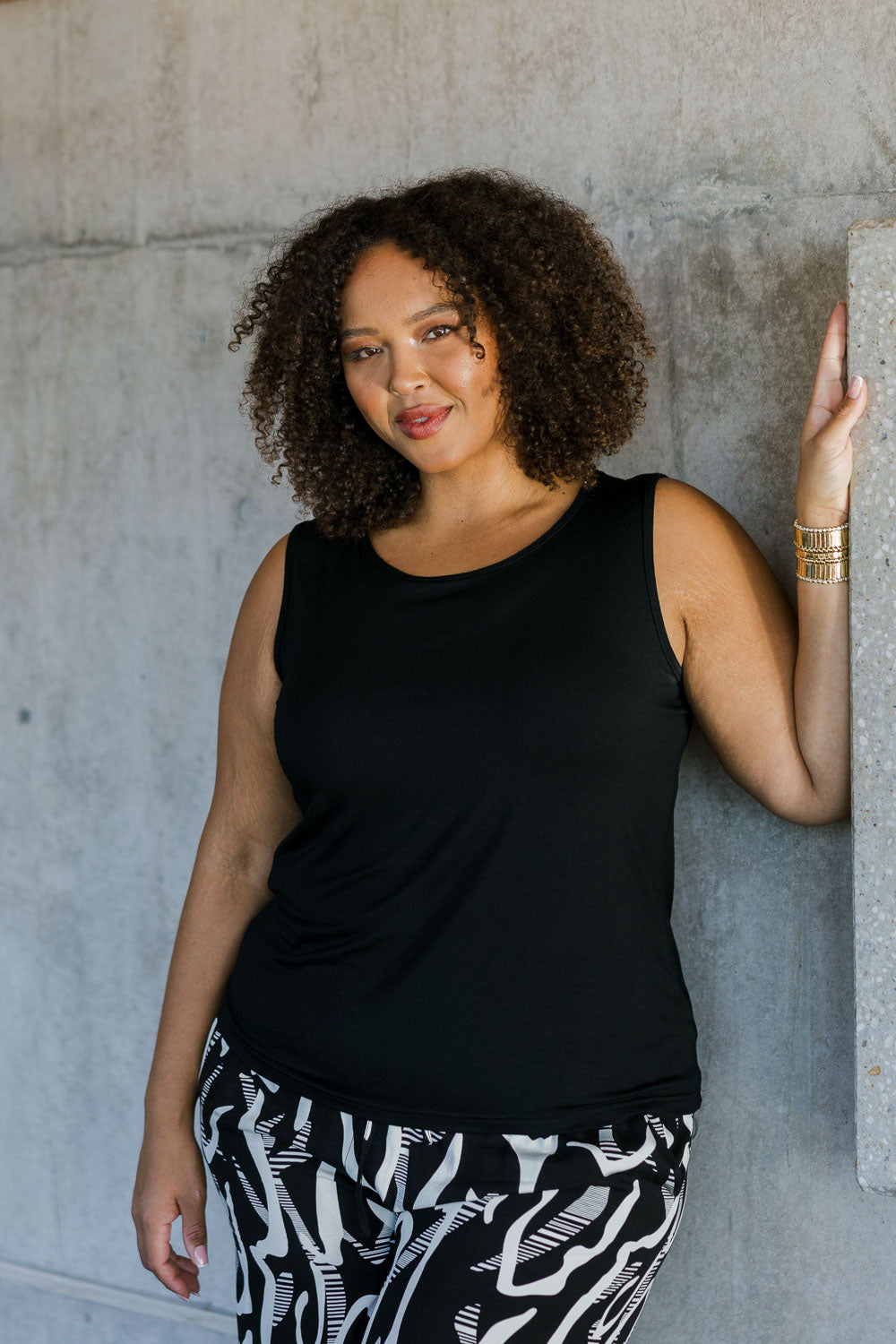 Model Alexis wearing size 18 of the Belle Luxe Bamboo Tank in colour Black (Black), from the front, showing the whole outfit
