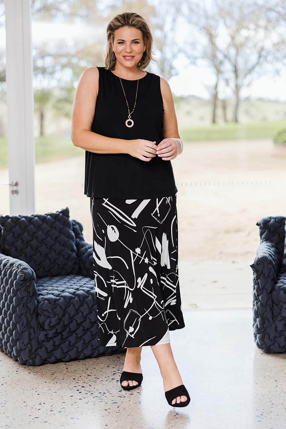 Model Fiona wearing size 16 of the Belle Fit & Flare Printed Skirt in colour Blackwhite (Black), from the front, showing the whole outfit