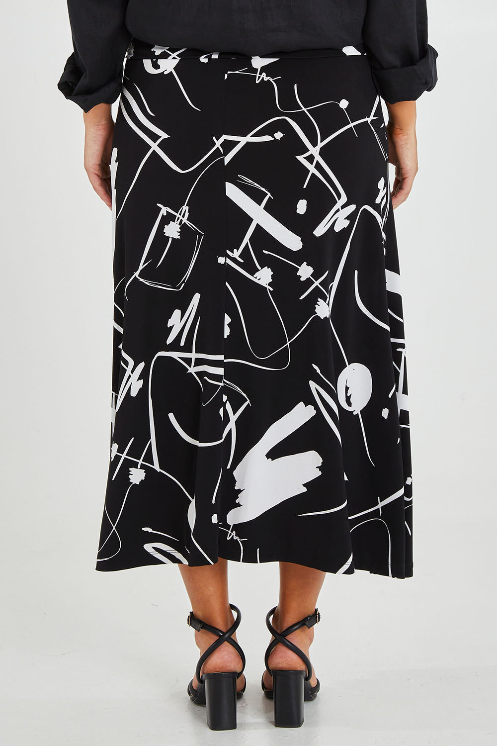 Model Monique wearing size 14 of the Belle Fit & Flare Printed Skirt in colour Blackwhite (Black), from the back