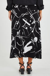 Model Monique wearing size 14 of the Belle Fit & Flare Printed Skirt in colour Blackwhite (Black), from the back