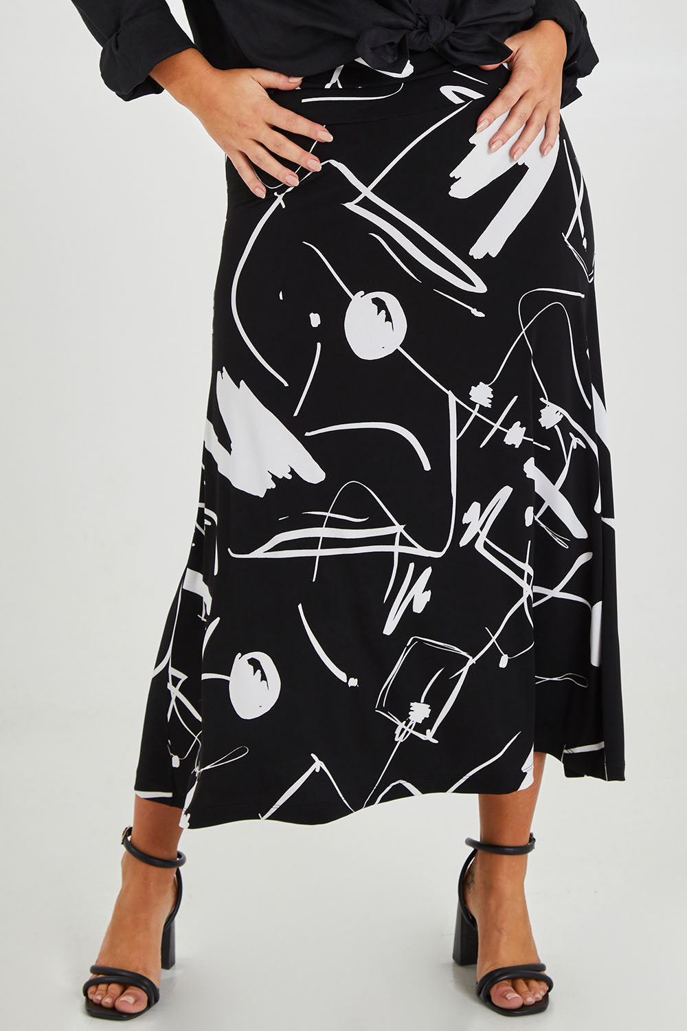Model Monique wearing size 14 of the Belle Fit & Flare Printed Skirt in colour Blackwhite (Black), from the front, cropped image