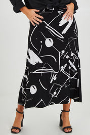 Model Monique wearing size 14 of the Belle Fit & Flare Printed Skirt in colour Blackwhite (Black), from the front, cropped image