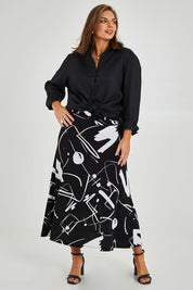 Model Monique wearing size 14 of the Belle Fit & Flare Printed Skirt in colour Blackwhite (Black), from the front, showing the whole outfit