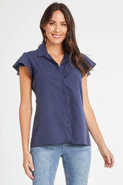 Model Madeline wearing size 10 of the Belle Flutter Sleeve Shirt in colour Navy (Blue), from the front, cropped image