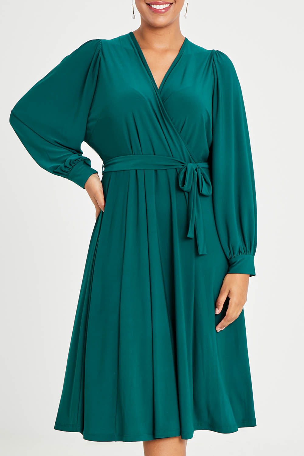 Model Noli wearing size 14 of the Belle Recycled Full Sleeve Dress in colour Teal (Green), from the front, cropped image