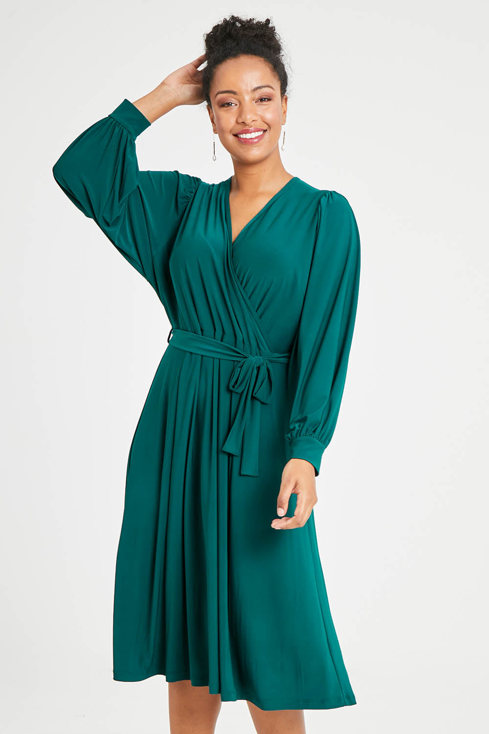 Model Noli wearing size 14 of the Belle Recycled Full Sleeve Dress in colour Teal (Green), from the front, cropped image