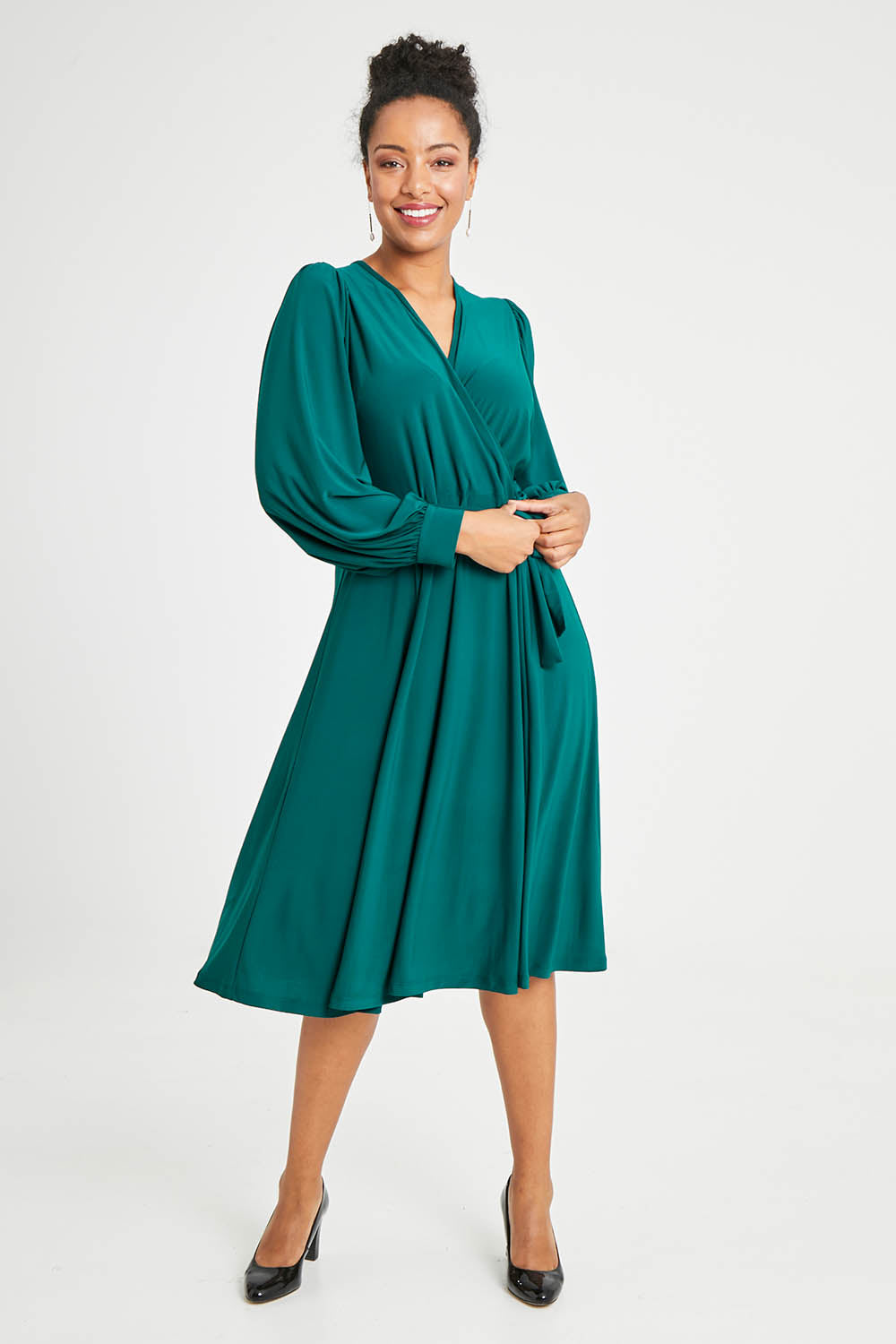 Model Noli wearing size 14 of the Belle Recycled Full Sleeve Dress in colour Teal (Green), from the front, showing the whole outfit