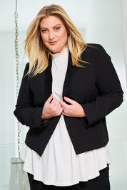 Model Caitlin wearing size 18 of the Belle Eyelet Detail Blazer in colour Black (Black), from the front, showing the whole outfit