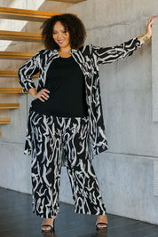 Model Alexis wearing size 18 of the Belle Relaxed Long Printed Shirt in colour Blackivory (Black), from the front, showing the whole outfit