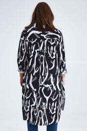 Model Monique wearing size 14 of the Belle Relaxed Long Printed Shirt in colour Blackivory (Black), from the back