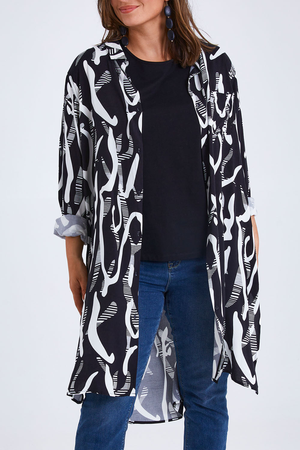 Model Monique wearing size 14 of the Belle Relaxed Long Printed Shirt in colour Blackivory (Black), from the front, cropped image