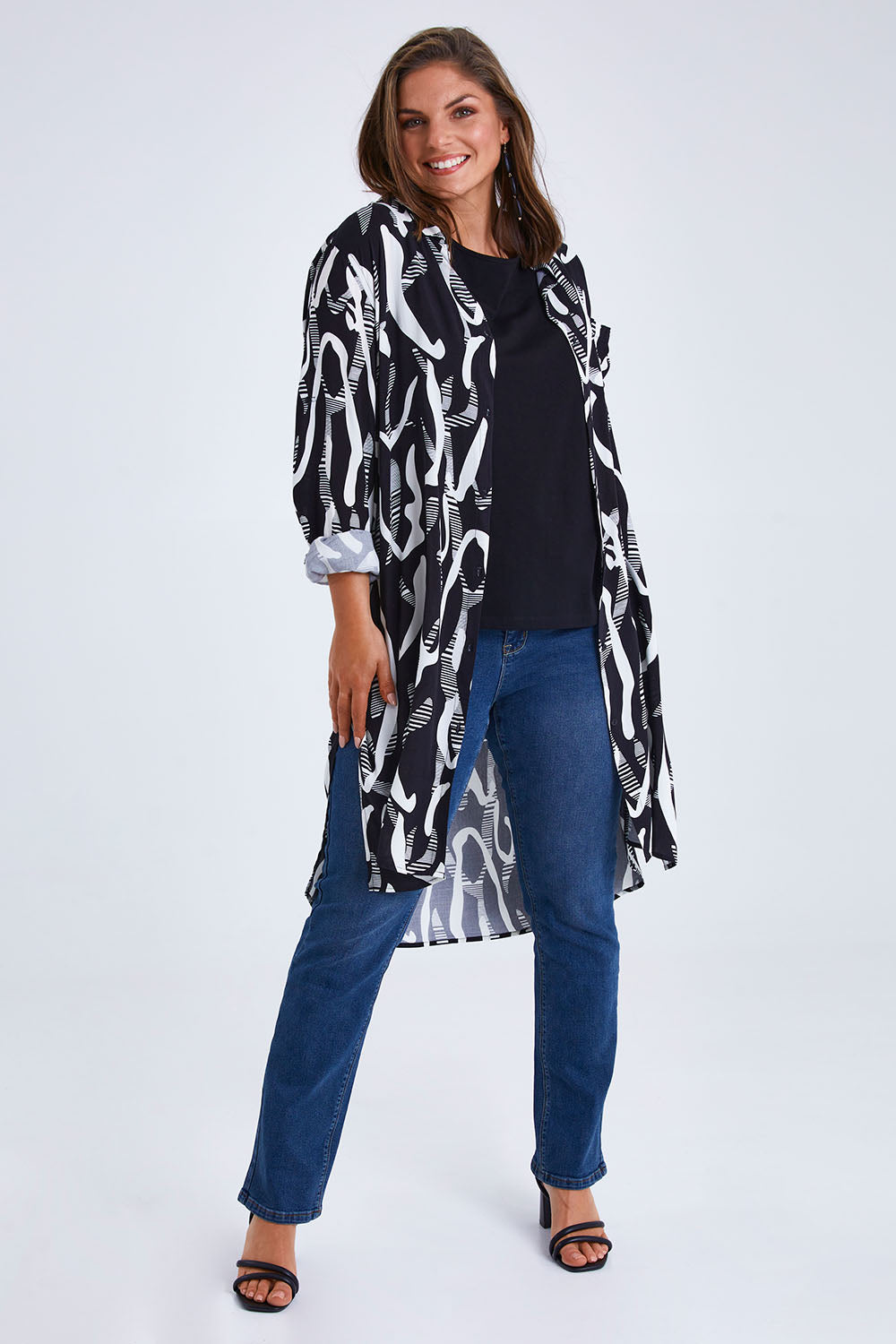 Model Monique wearing size 14 of the Belle Relaxed Long Printed Shirt in colour Blackivory (Black), from the front, showing the whole outfit