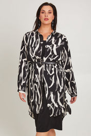 Model Poppy wearing size 16 of the Belle Relaxed Long Printed Shirt in colour Blackivory (Black), from the front, cropped image