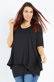 Model Laura wearing size 12 of the Belle Half Sleeve Forgiver Tunic in colour Black (Black), from the front, cropped image