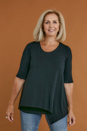 Model Sandy wearing size 10 of the Belle Half Sleeve Forgiver Tunic in colour Black (Black), from the front, cropped image