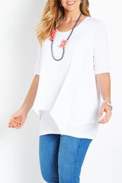 Model Bree wearing size 14 of the Belle Half Sleeve Forgiver Tunic in colour White (White), from the front, cropped image