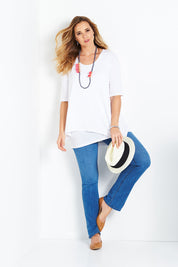 Model Bree wearing size 14 of the Belle Half Sleeve Forgiver Tunic in colour White (White), from the front, showing the whole outfit