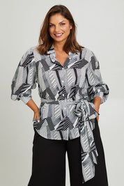 Model Monique wearing size 14 of the Belle Full Sleeve Printed Shirt in colour Blackivory (Black), from the front, cropped image