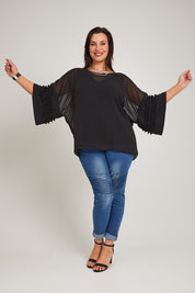 Model Poppy wearing size 16 of the Belle Chiffon Bubble Detail Top w/Cami in colour Black (Black), from the front, showing the whole outfit