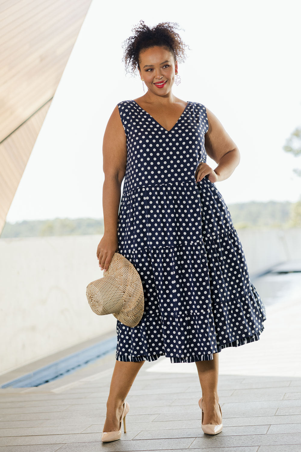 Model Alexis wearing size 18 of the Belle V Neck Reversible Dress in colour Navywhite (Blue), from the front, showing the whole outfit