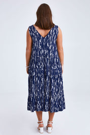 Model Monique wearing size 14 of the Belle V Neck Reversible Dress in colour Navywhite (Blue), from the back
