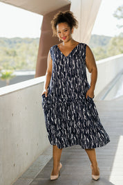 Model Monique wearing size 18 of the Belle V Neck Reversible Dress in colour Navywhite (Blue), from the front, showing the whole outfit
