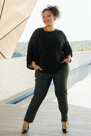 Model Alexis wearing size 18 of the Belle Check Pull on Pant in colour Blackwhite (Black), from the front, showing the whole outfit