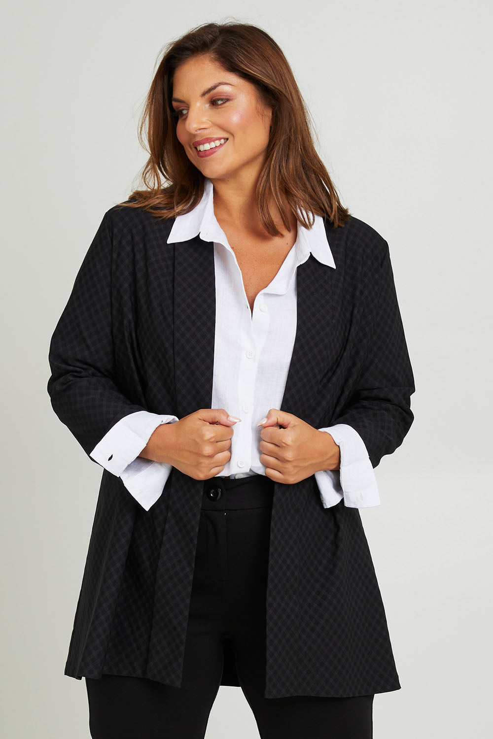 Model Monique wearing size 14 of the Belle Checked Jacket in colour Blackgrey (Black), from the front, cropped image