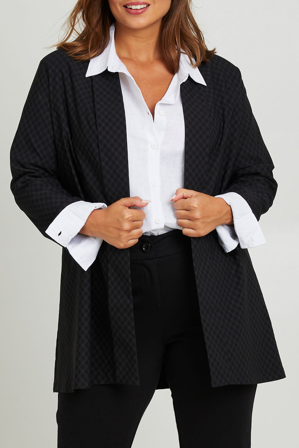 Model Monique wearing size 14 of the Belle Checked Jacket in colour Blackgrey (Black), from the front, cropped image