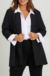 Model Monique wearing size 14 of the Belle Checked Jacket in colour Blackgrey (Black), from the front, cropped image