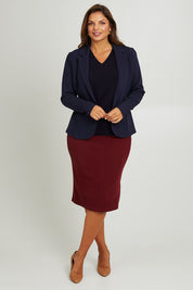 Model Monique wearing size 14 of the Belle Textured Pull On Skirt in colour Cranberry (Red), from the front, showing the whole outfit