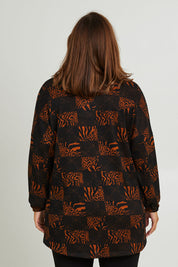 Model Monique wearing size 14 of the Belle Soft Knit Printed Top in colour Navytan (Blue), from the back