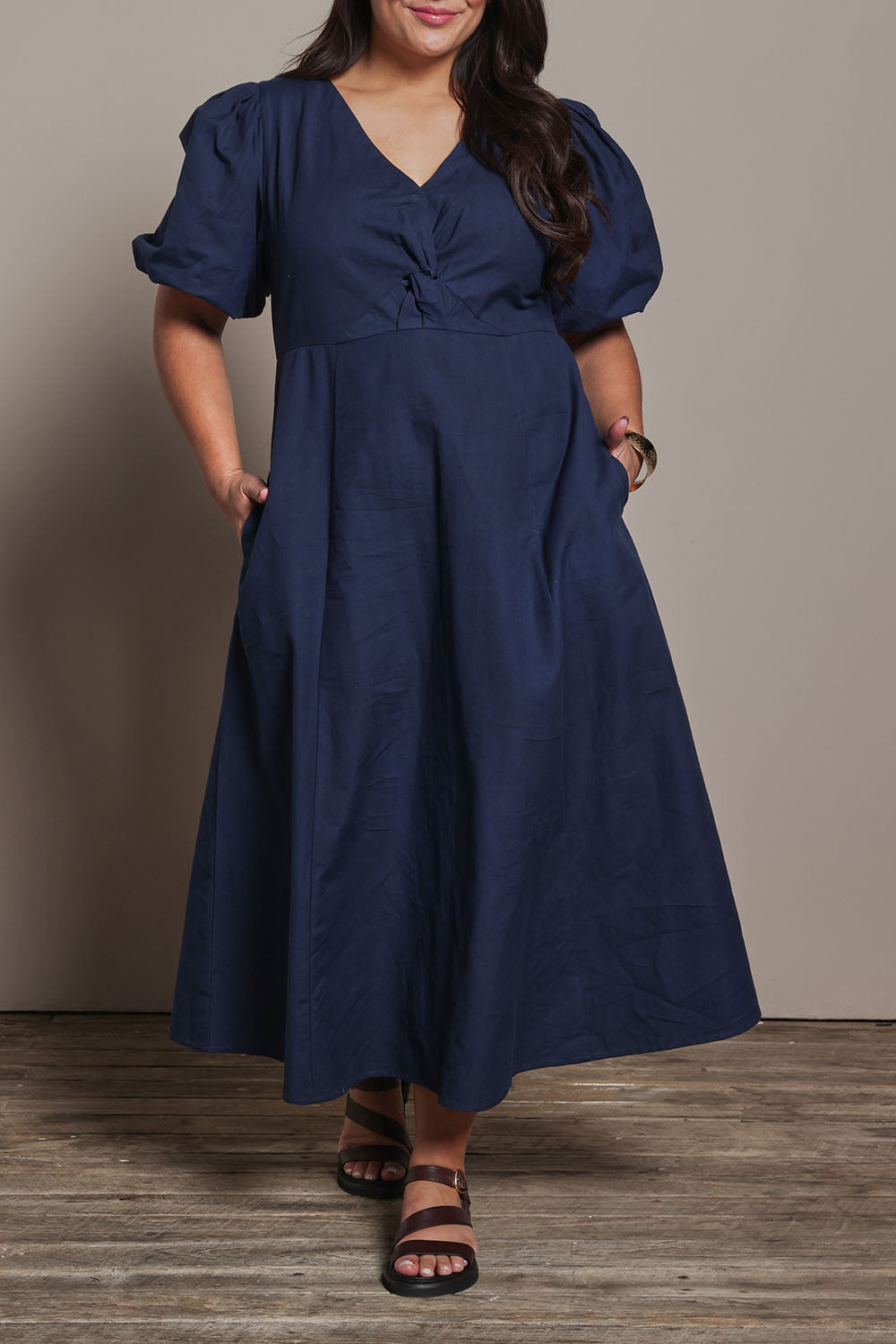 Model Ashleigh wearing size 16 of the Belle Twist Knot Detail Cotton Dress in colour Darknavy (Blue), from the front, cropped image