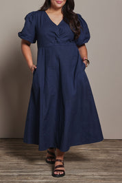 Model Ashleigh wearing size 16 of the Belle Twist Knot Detail Cotton Dress in colour Darknavy (Blue), from the front, cropped image