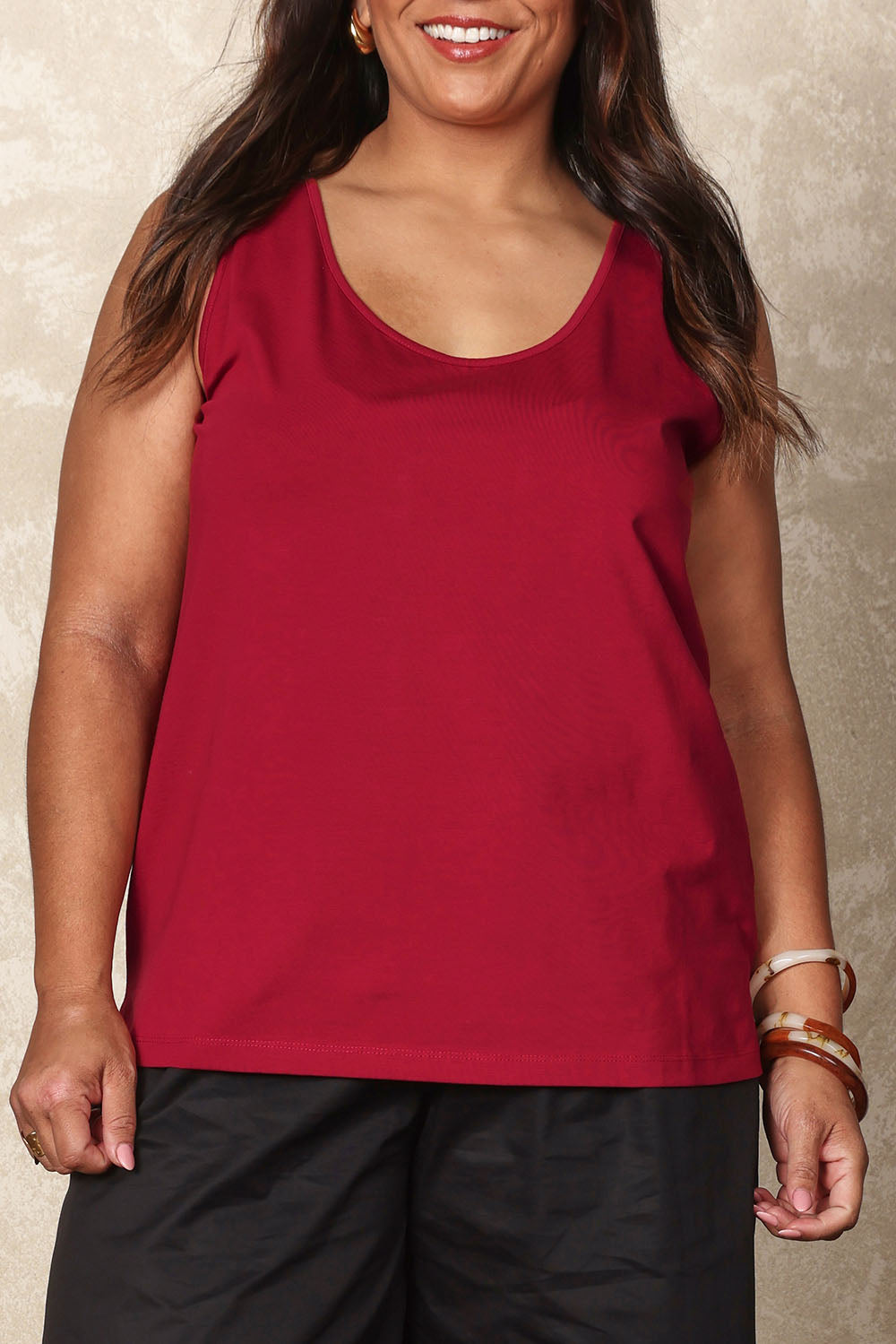 Model Ashleigh wearing size 16 of the Belle Luxe Cotton Tank in colour Chilli (Red), from the front, cropped image