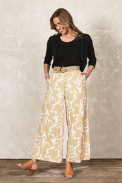 Model Olivia wearing size 10 of the Belle Printed Cotton Wide Leg Pant in colour Croissant, from the front, showing the whole outfit