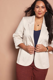 Model Ashleigh wearing size 16 of the Belle Cotton Comfort Blazer in colour Stone, from the front, cropped image