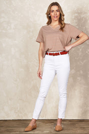Model Olivia wearing size 10 of the Belle Classic Fit High Waisted Jean in colour White (White), from the front, showing the whole outfit