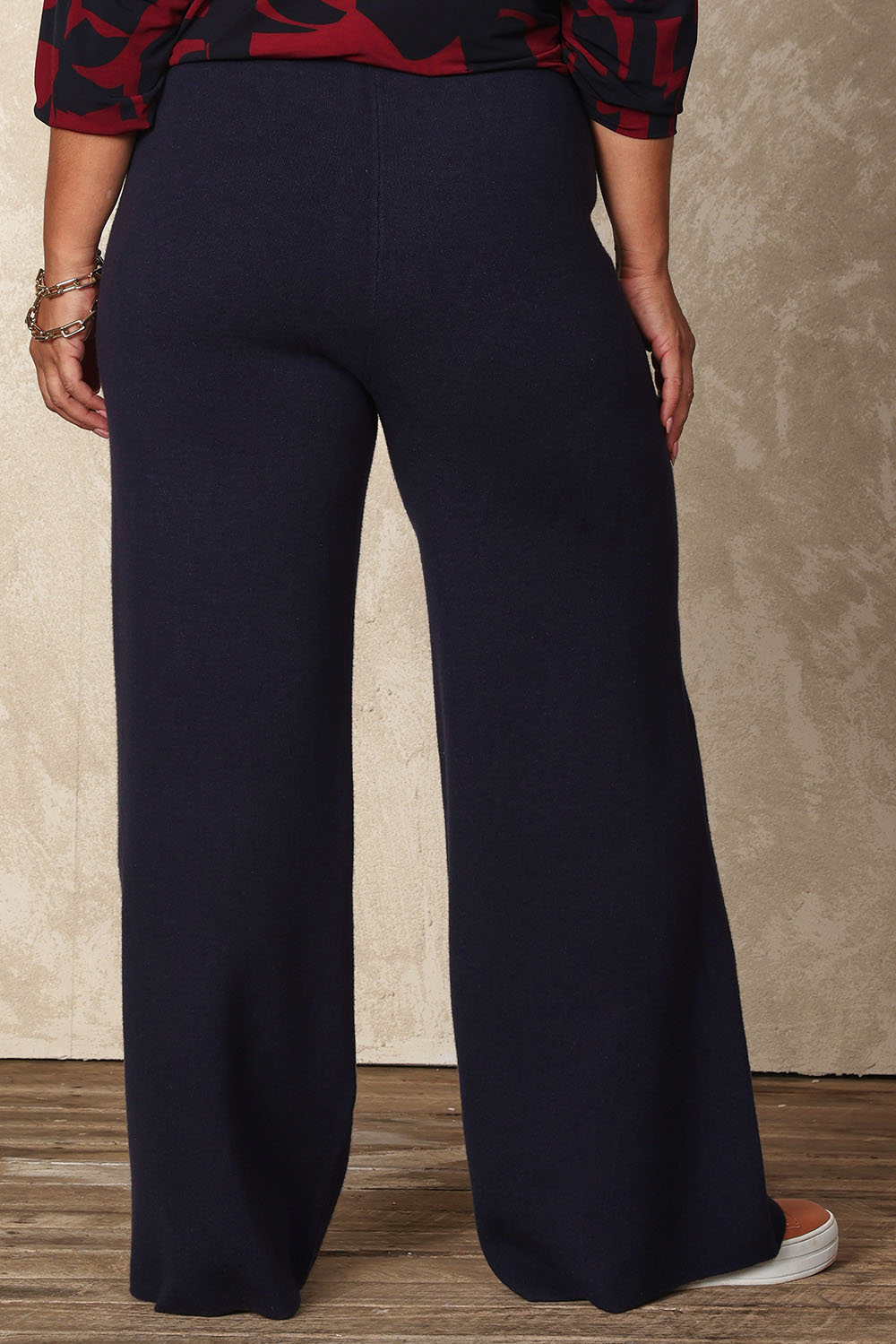 Model Ashleigh wearing size XL of the Belle Cosy Knit Pull On Wide Leg Pants in colour Navy (Blue), from the back