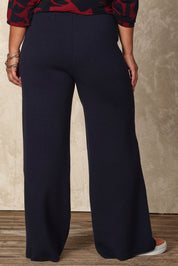 Model Ashleigh wearing size XL of the Belle Cosy Knit Pull On Wide Leg Pants in colour Navy (Blue), from the back