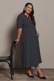 Model Ashleigh wearing size 16 of the Belle Fluted A Line Dress With Pockets in colour Blackwhite (Black), from the front, showing the whole outfit