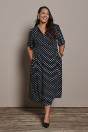 Model Ashleigh wearing size 16 of the Belle Fluted A Line Dress With Pockets in colour Blackwhite (Black), from the front, showing the whole outfit