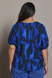 Model Ashleigh wearing size 16 of the Belle Cotton Printed V Neck Top in colour Trioofblue (Blue), from the back