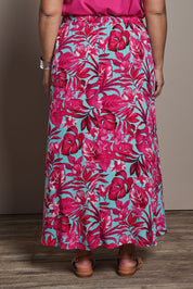 Model Ashleigh wearing size 16 of the Belle Printed Pull On Full Skirt with Pockets in colour Aquafusch (Pink), from the back