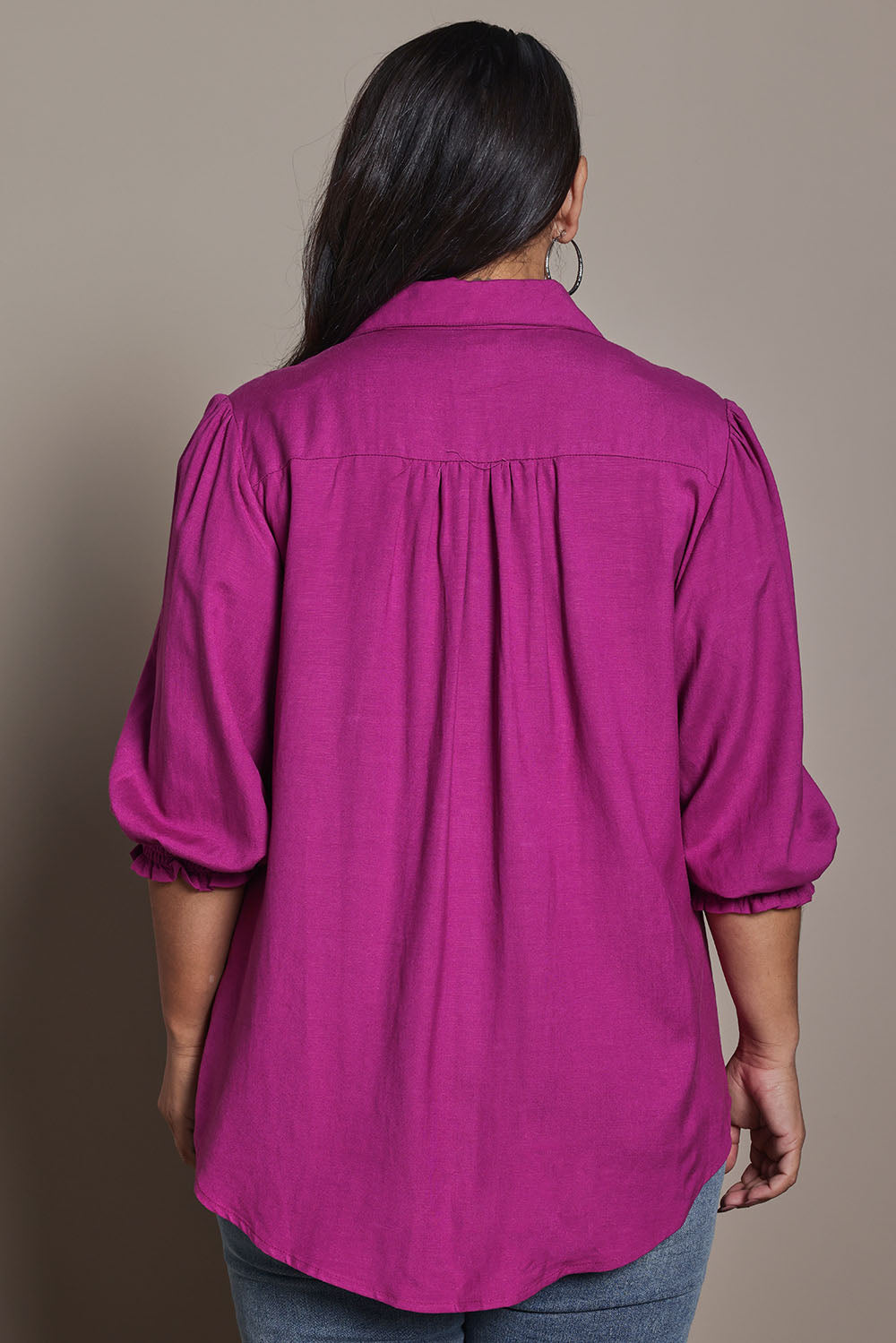 Model Ashleigh wearing size 16 of the Belle Luxe Shirred Sleeve Shirt in colour Magenta (Pink), from the back